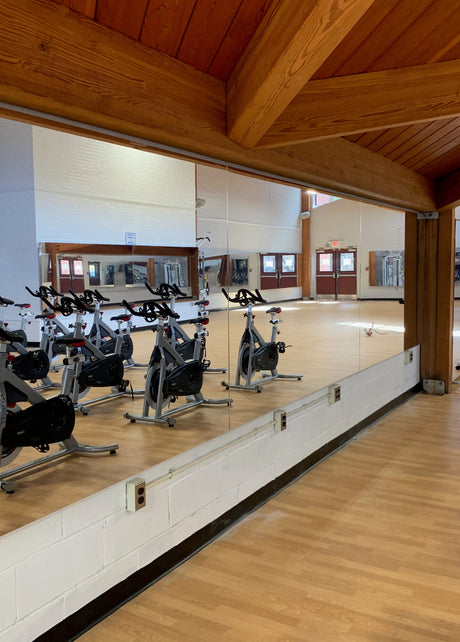 Wall mount and portable mirrors installed in a modern fitness studio