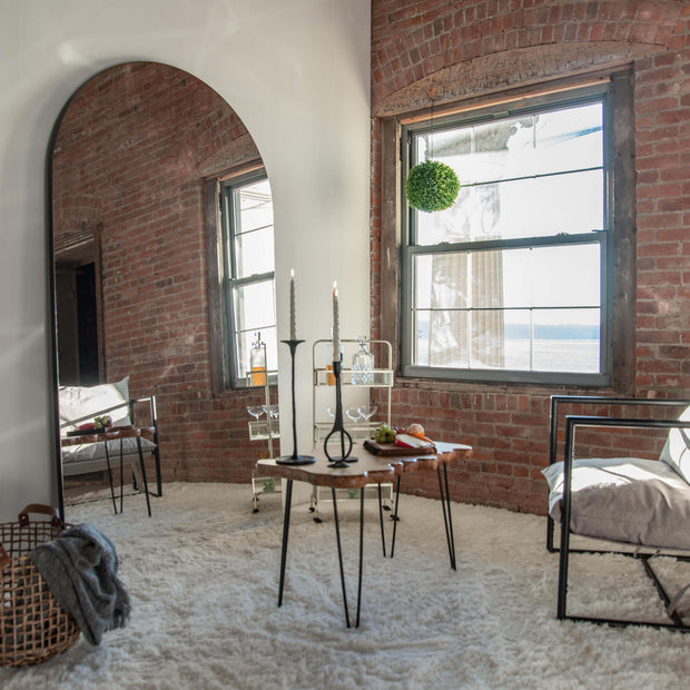 Arched, full-length mirror in a mid-century modern living room