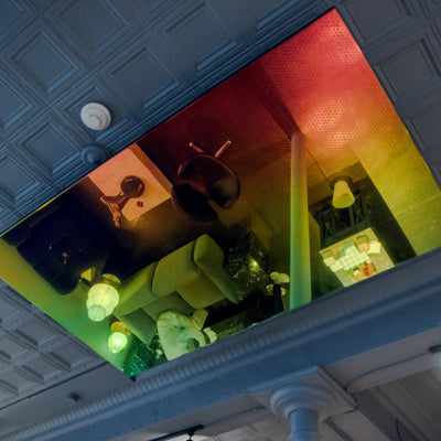 Ceiling with a reflective iridescent mirror showing interior decor and lighting