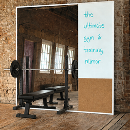Gym mirror featuring integrated whiteboard and cork panel with weightlifting equipment against a brick wall.
