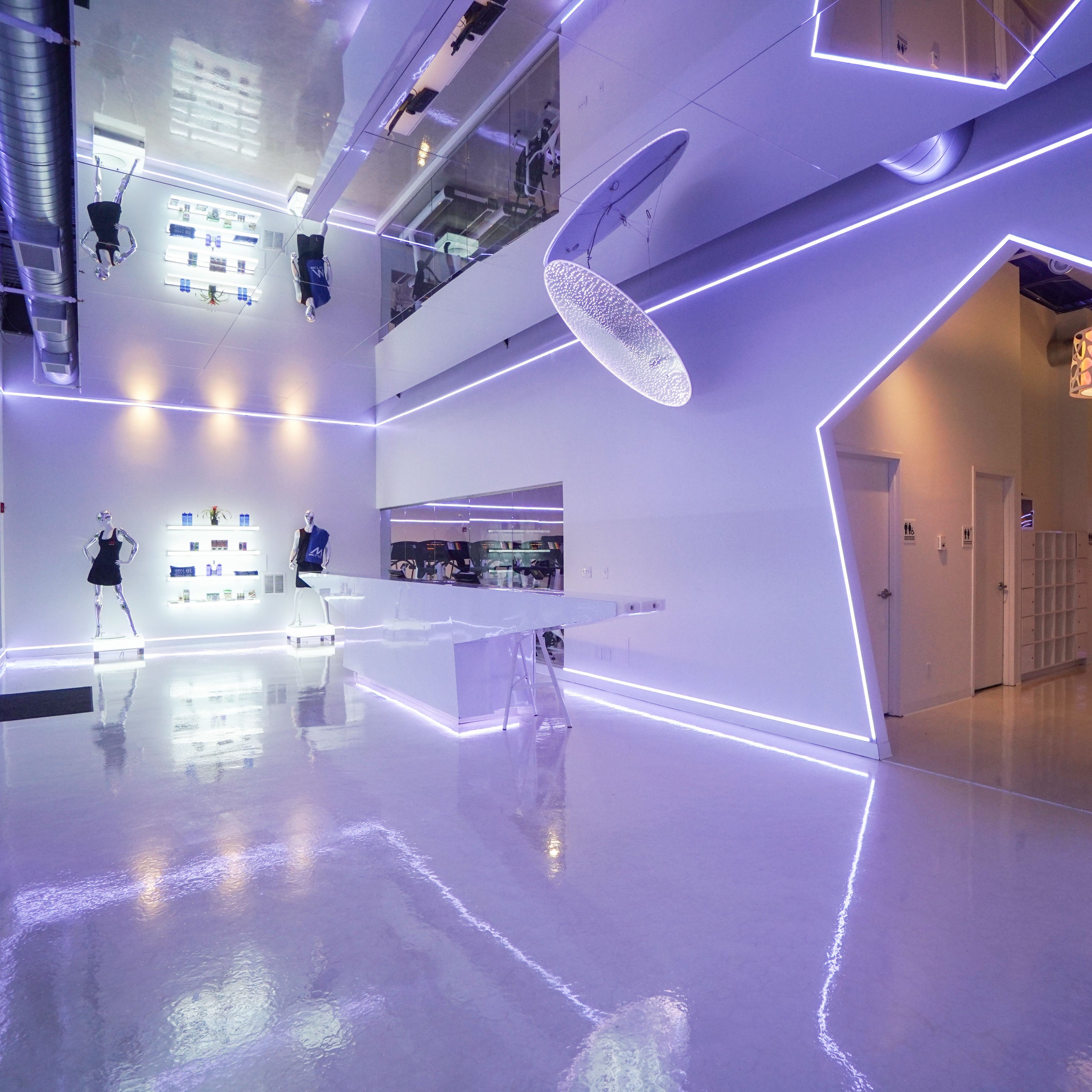 Modern fitness center with neon lights and LiteMirror ceiling tiles