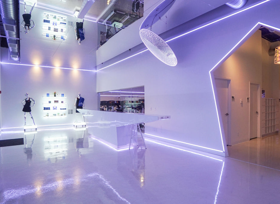 Modern fitness center with neon lights and LiteMirror ceiling tiles