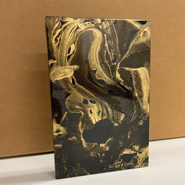 Decorative mirror with gold and black antique design on a brown background