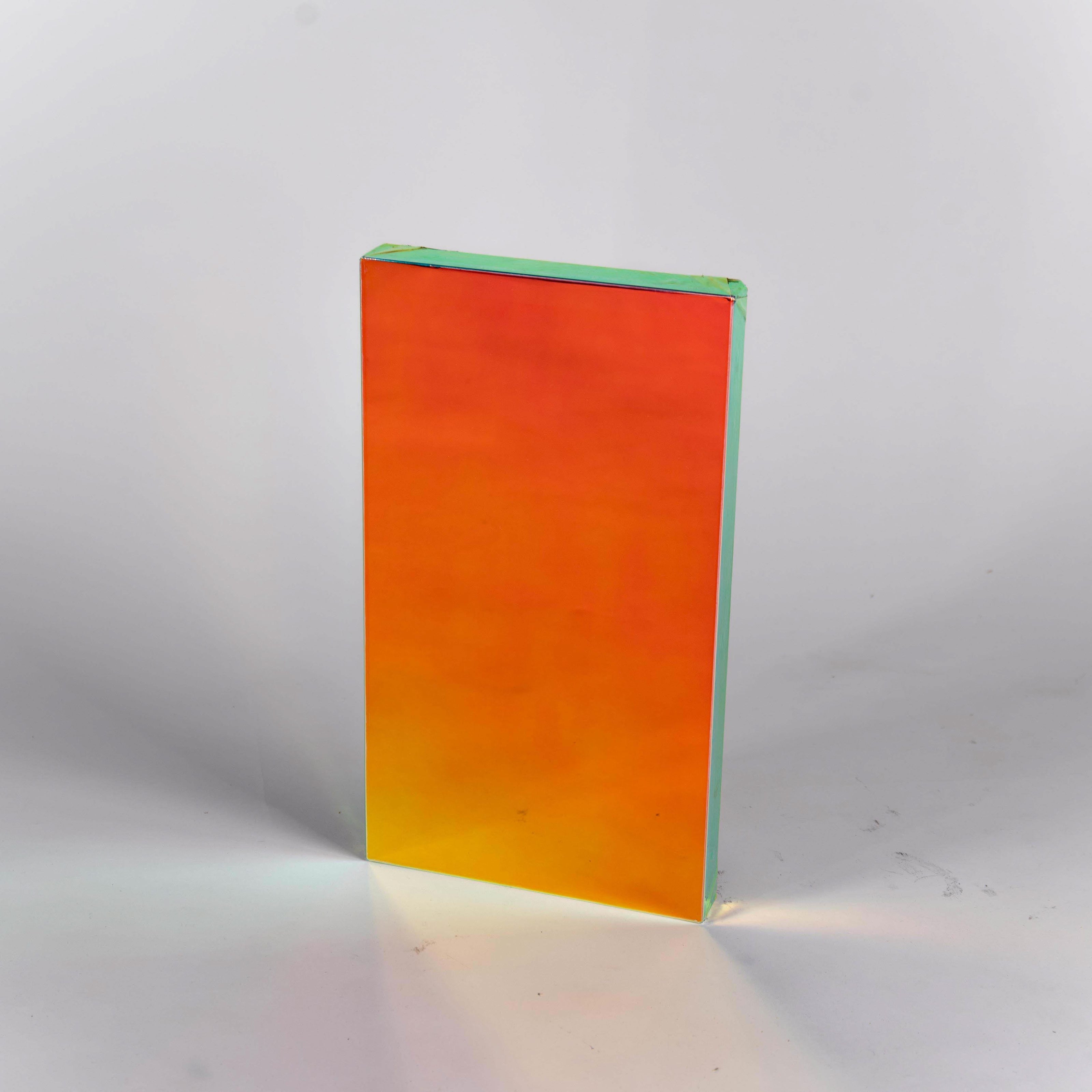 Rectangular mirror panel with a gradient color transitioning from red to yellow on a white background