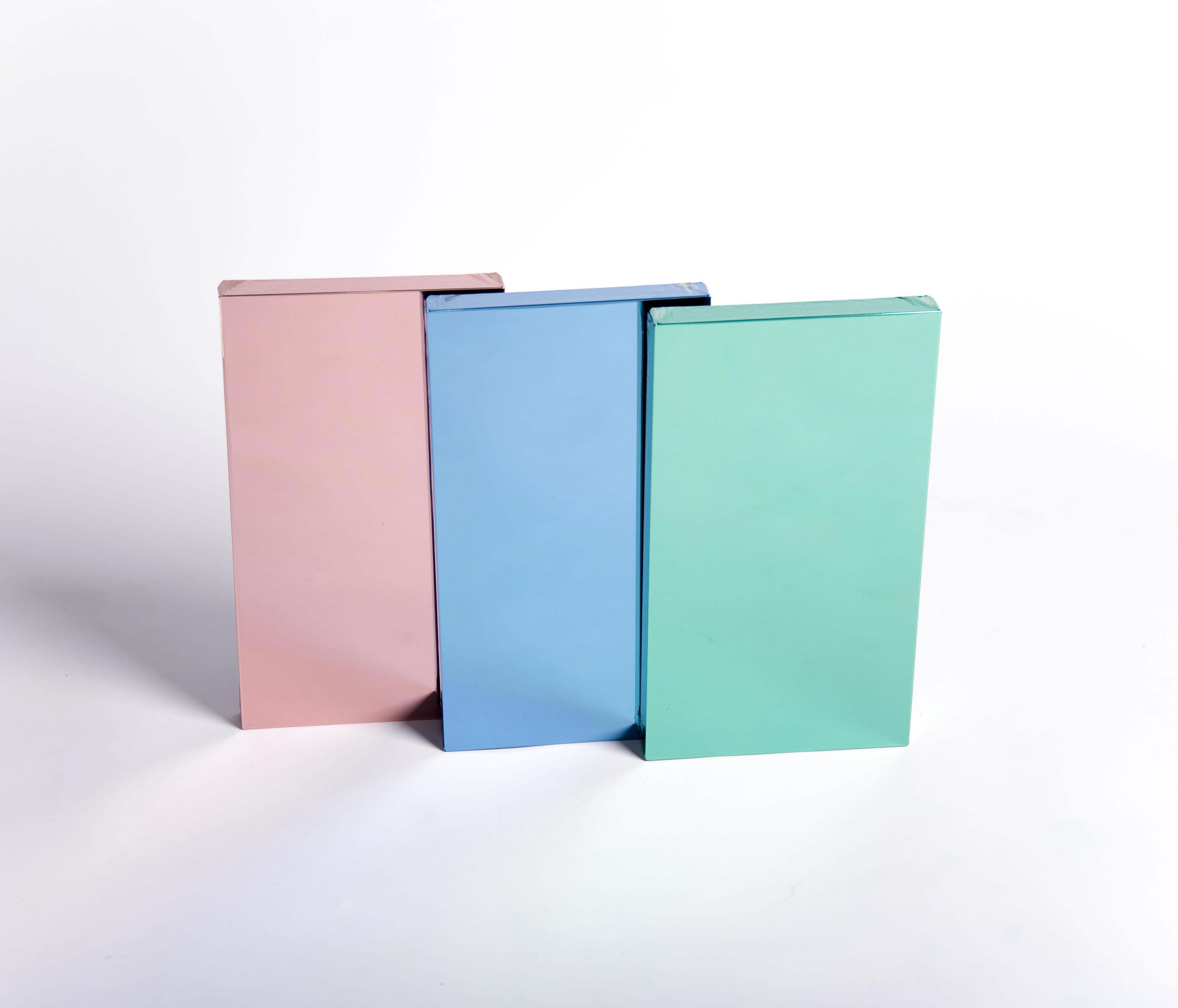 Rose, teal and blue film mirror color samples on white background