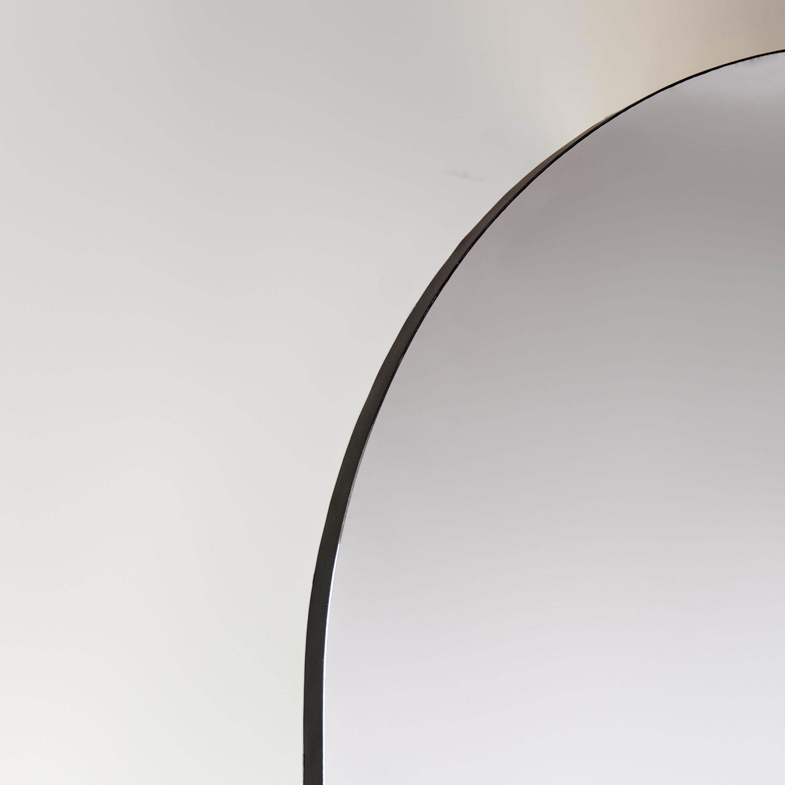 Arched mirror with black edging on a white background