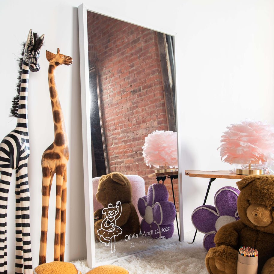 Children's room with stuffed animals, a customized mirror, and decorative items.
