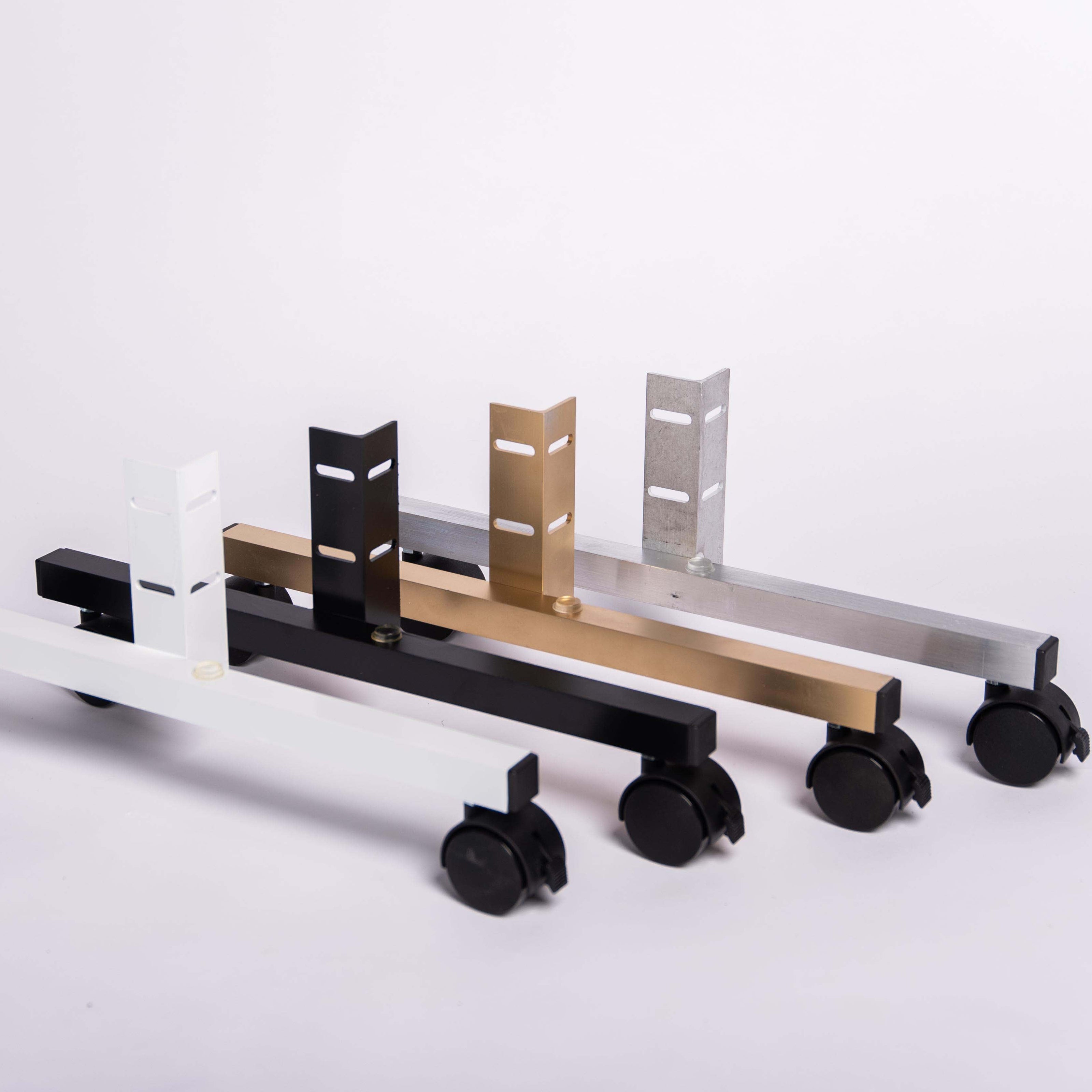 Set of portable rolling stands in white, black, gold and silver against a white background
