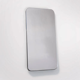 Wall mounted mirror with rounded corners on white backdrop 