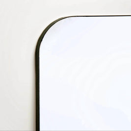 Close-up of a mirror with black edging on a white background
