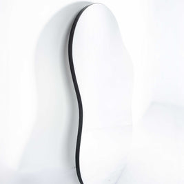 Irregular-shaped mirror with black edging on white background