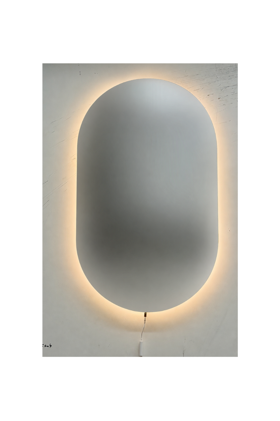Oval shatterproof mirror with a glowing light strip on a white wall