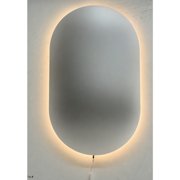 Oval shatterproof mirror with a glowing light strip on a white wall